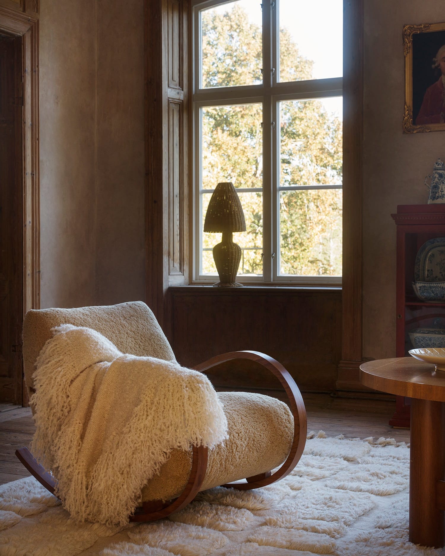Handwoven soft off-white wool rug in a rustic room. 